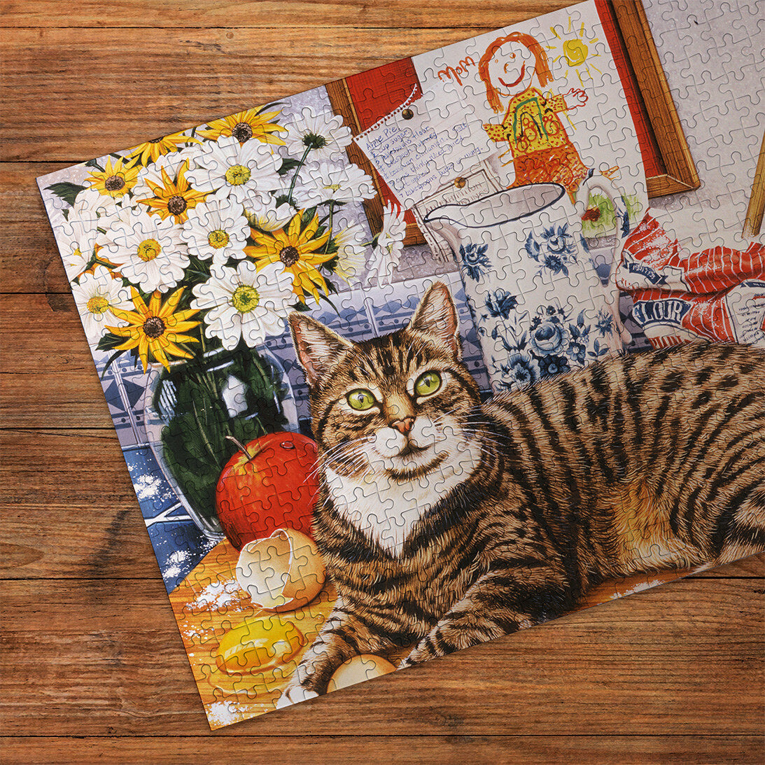 A Cracking Bake 100XXL puzzle in blue Gibsons made up detail on wooden table