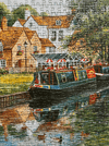 Jigsaw puzzle with a completed scene of a boat on a canal in a village.