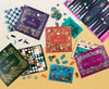 Collection of board games including chess, bingo, sudoku, dominoes, and shut the box on a beige surface.