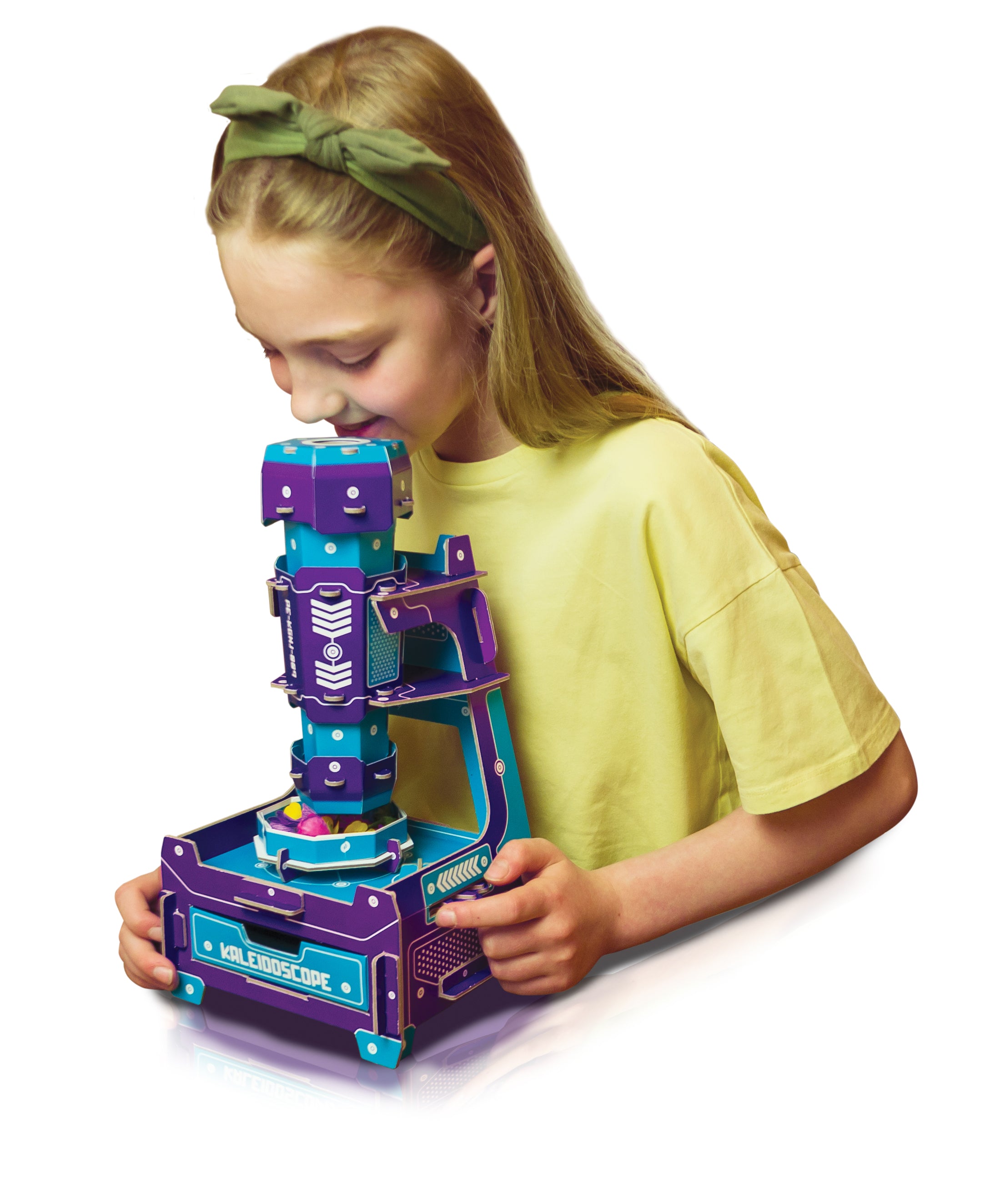 A young girl with a green bow headband and yellow t-shirt is looking through a purple and teal toy microscope on a white background.