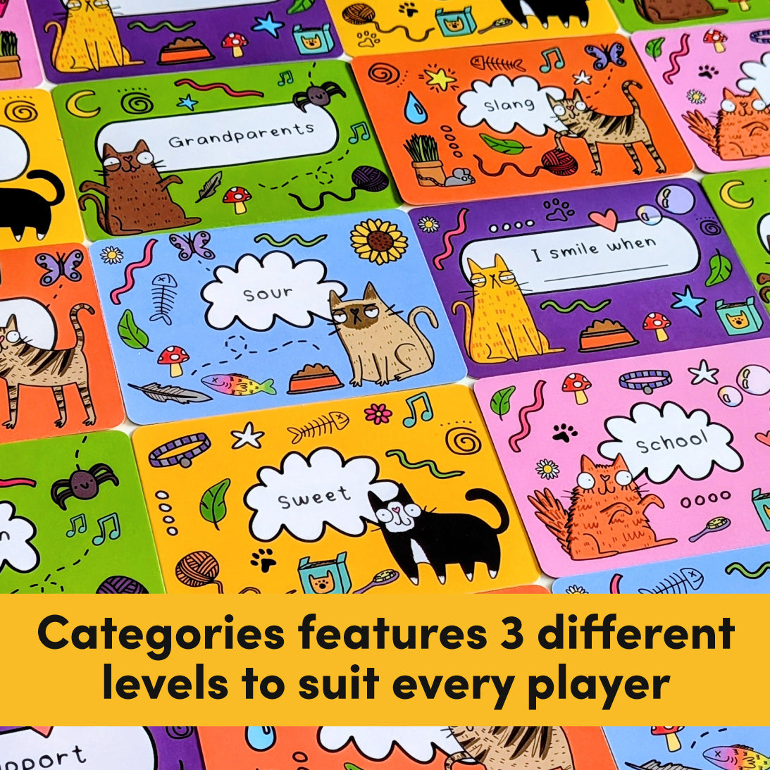 A close-up of colourful rectangular cards arranged in a grid, each with cartoon cat illustrations and text such as 'Grandparents,' 'Sour,' 'I smile when,' 'Sweet,' and 'School.' A yellow banner across the bottom reads, 'Categories features 3 different levels to suit every player.