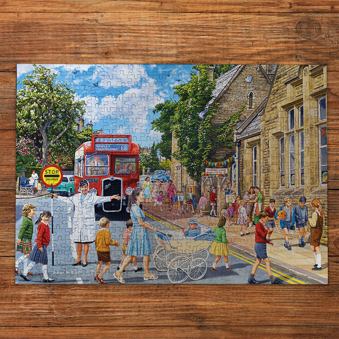The Lollipop Lady Extra Large 100XXL Piece Jigsaw Puzzle made up on wooden table