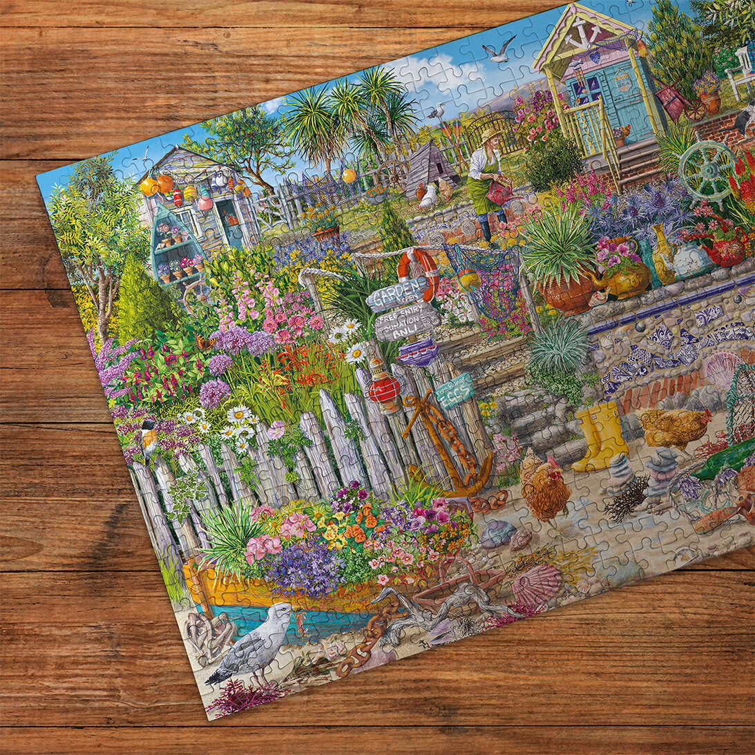 Beachcomber's Garden Extra Large 250XL Piece Jigsaw Puzzle made up detail on wooden table