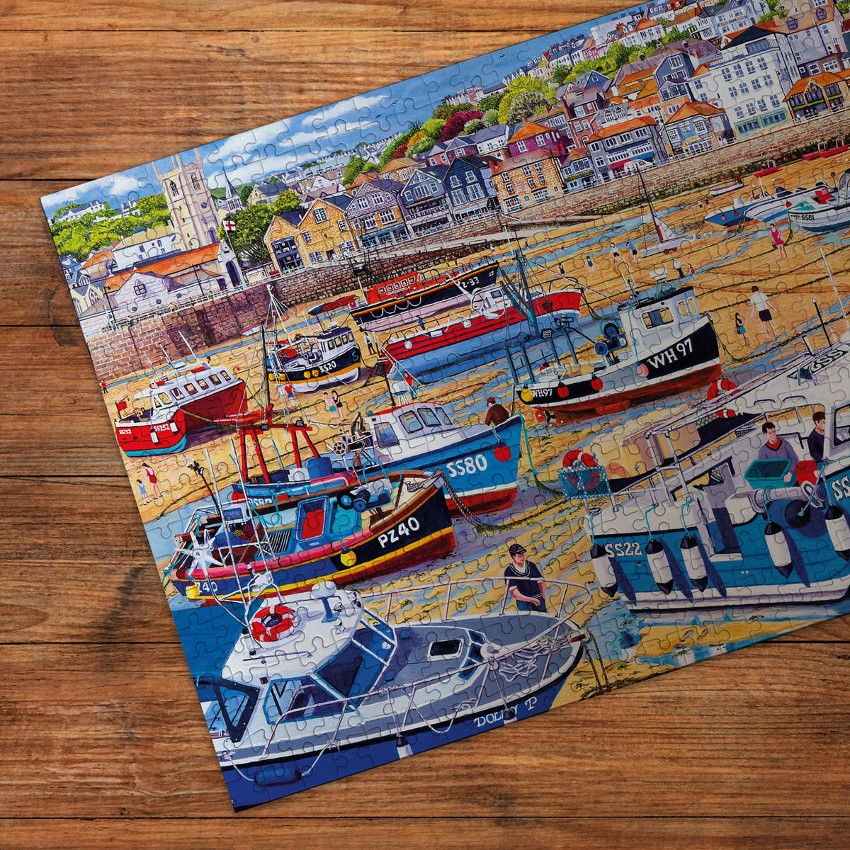 Jigsaw puzzle with a harbor scene on a wooden surface