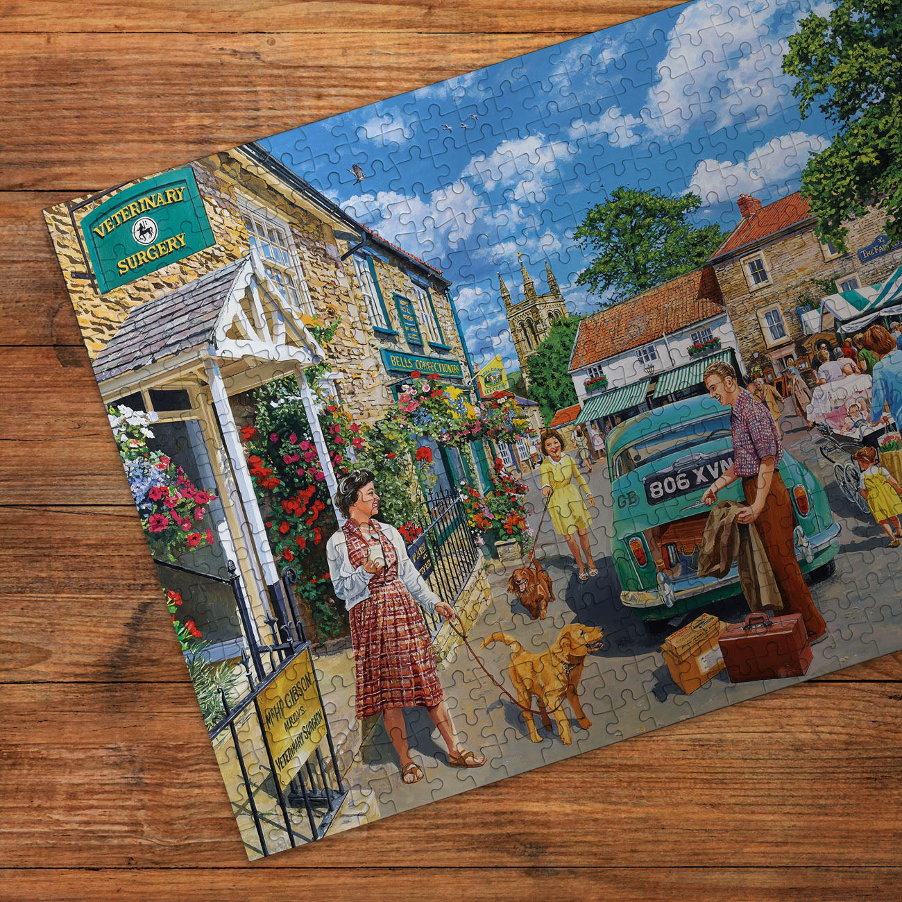 Jigsaw puzzle with a village scene on a wooden surface
