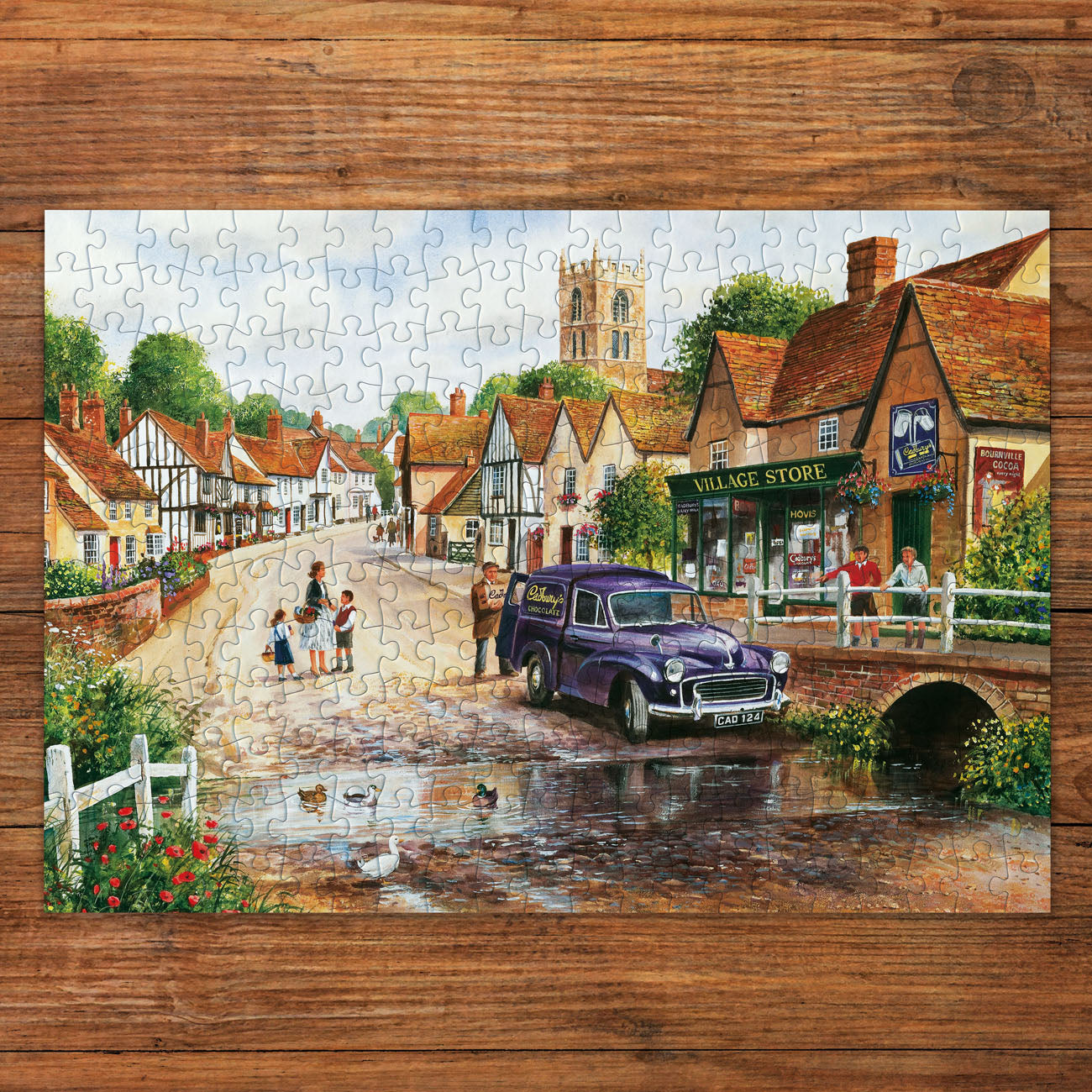 Jigsaw puzzle with a village scene on a wooden surface