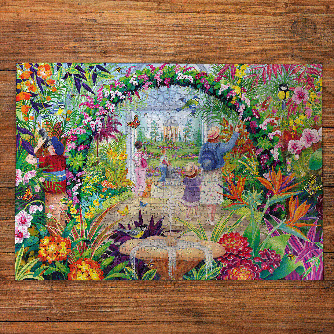 Botanical Blooms 500 Piece Jigsaw Puzzle by Gibson made up on wooden table