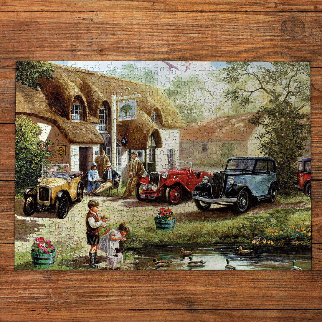 Feeding the Ducks 500 Piece Jigsaw Puzzle by Gibsons made up on wooden table