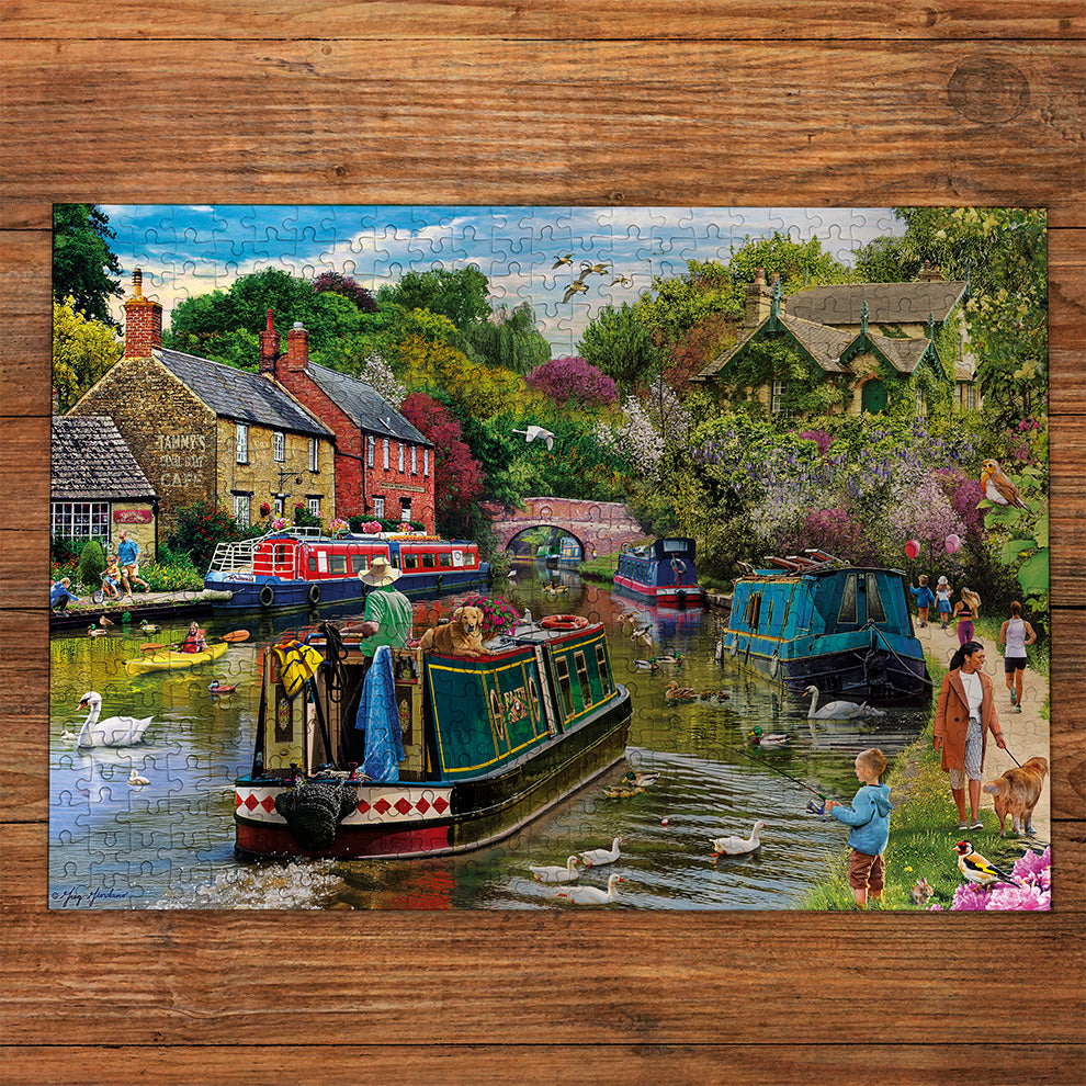 Gibsons River Retreat 500 Piece Jigsaw Puzzle made up on wooden table