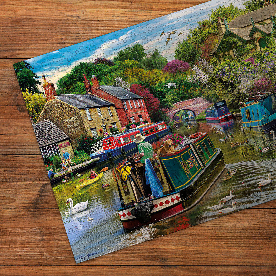 Gibsons River Retreat 500 Piece Jigsaw Puzzle made up detail on wooden table