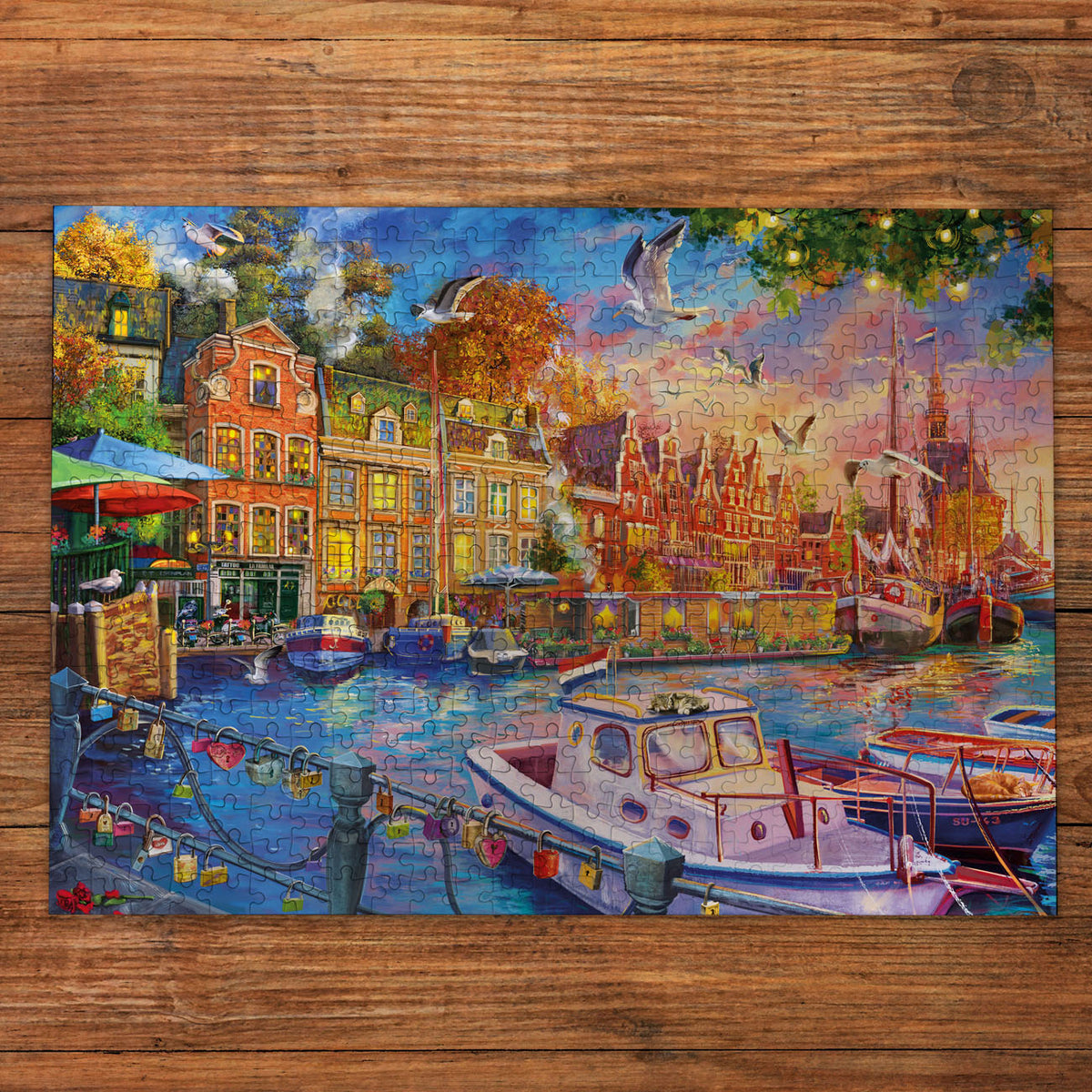 Colourful painting of a canal scene with boats and buildings on a wooden surface- Jigsaw puzzle