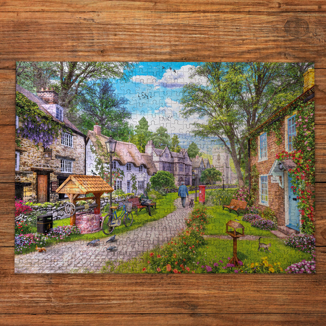Jigsaw puzzle of a quaint village scene on a wooden surface