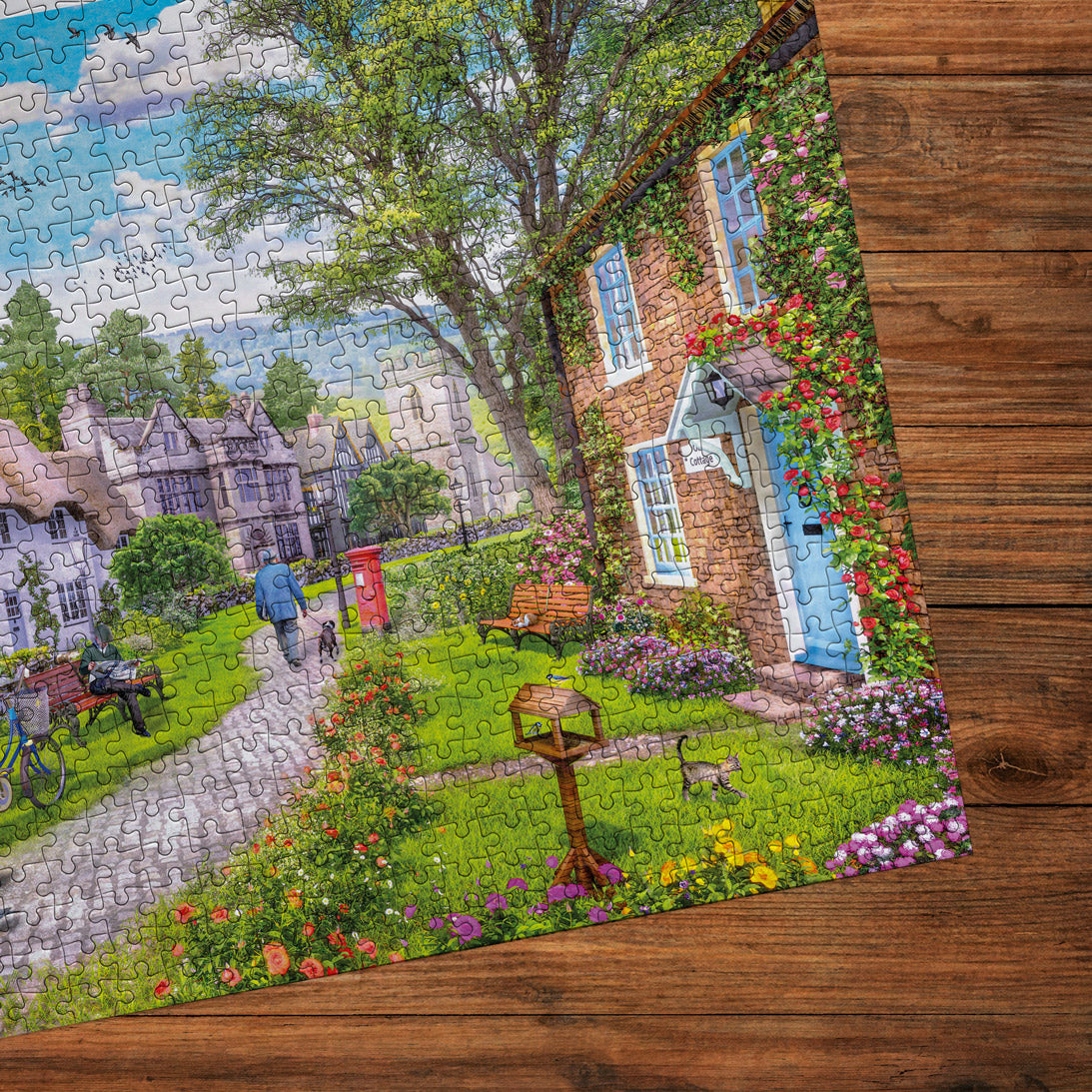 Jigsaw puzzle of a scenic village with a house and garden on a wooden surface