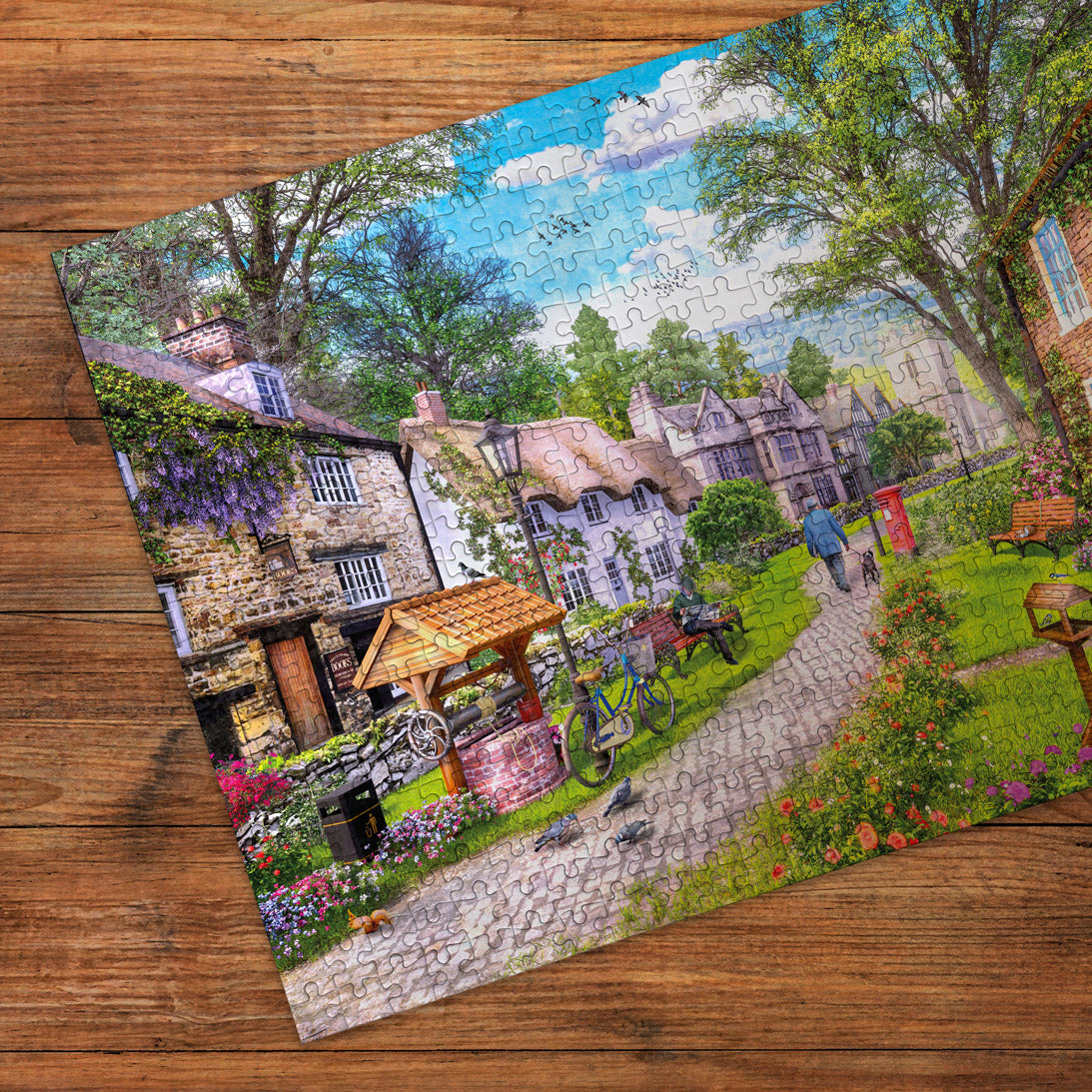 Jigsaw puzzle of a village scene on a wooden surface