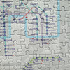 Jigsaw puzzle with a map of London's underground system on a white background