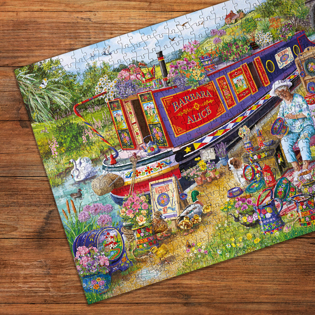Colorful puzzle with a boat and garden scene on a wooden surface