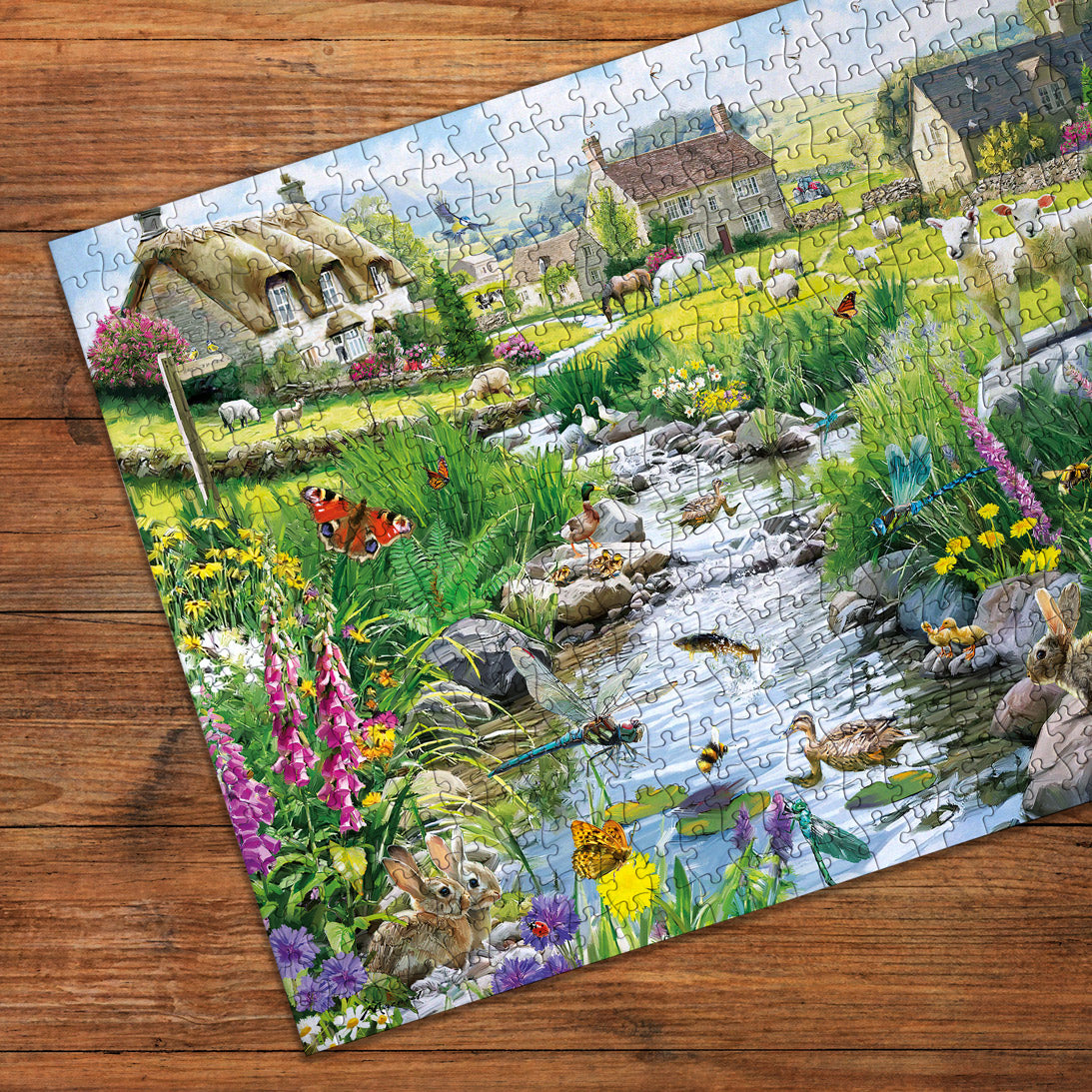 Jigsaw puzzle with a scenic countryside design on a wooden surface