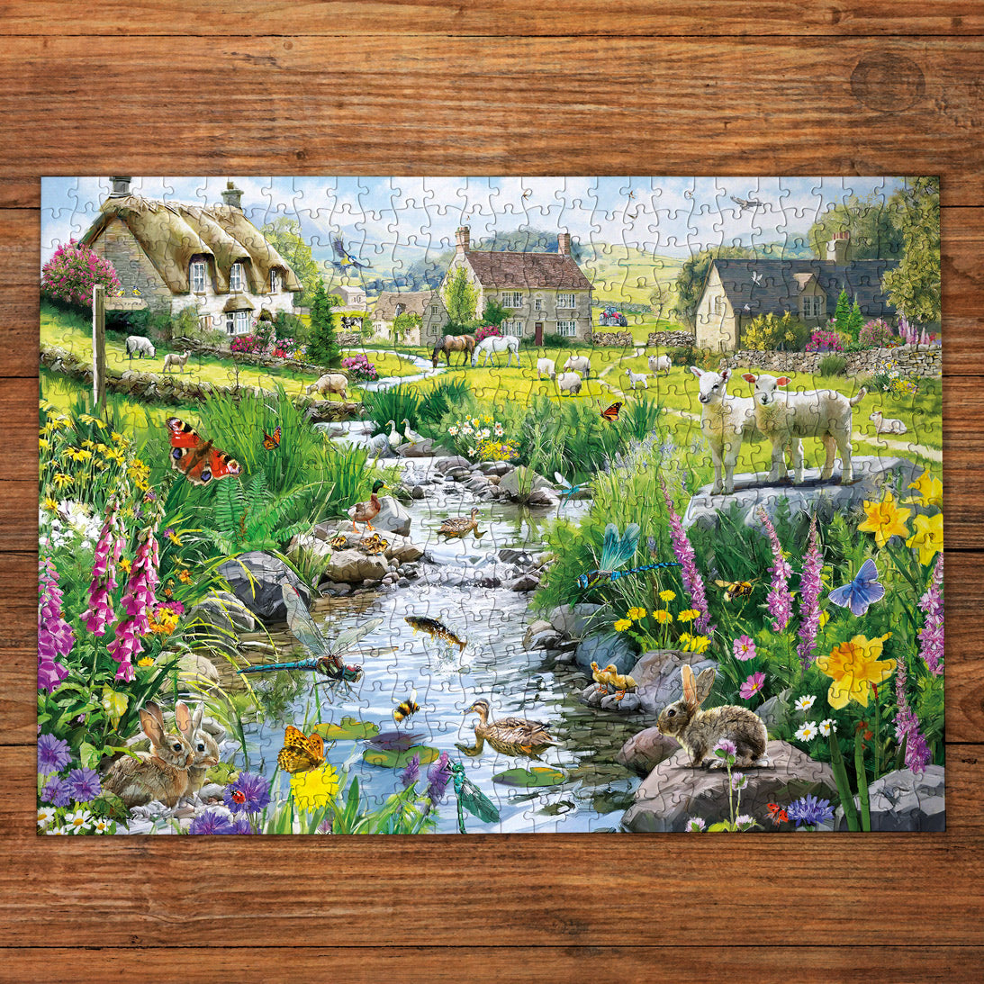 Colorful puzzle with a scenic village and nature design on a wooden surface