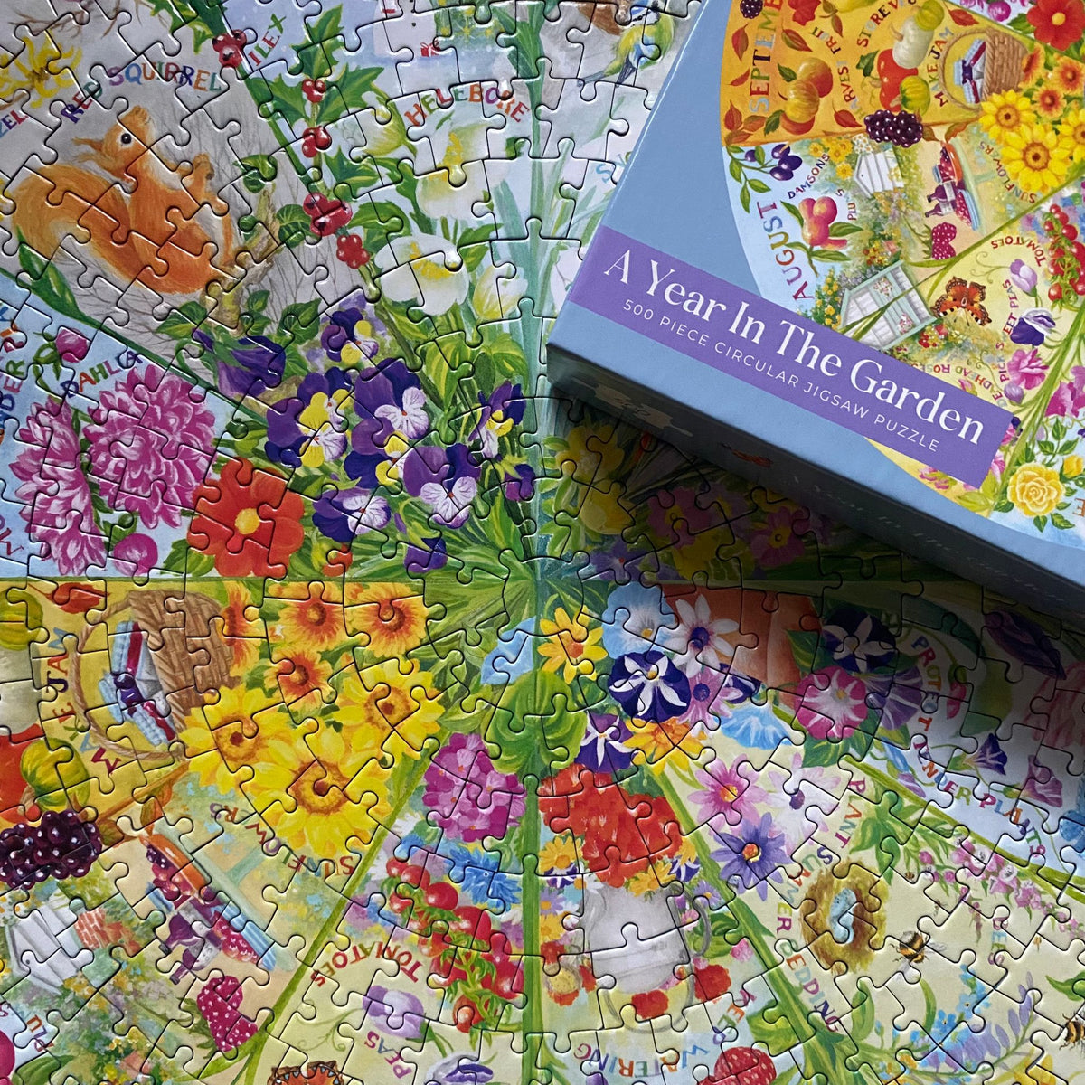 Circular puzzle titled 'A Year in the Garden' with completed sections and packaging.
