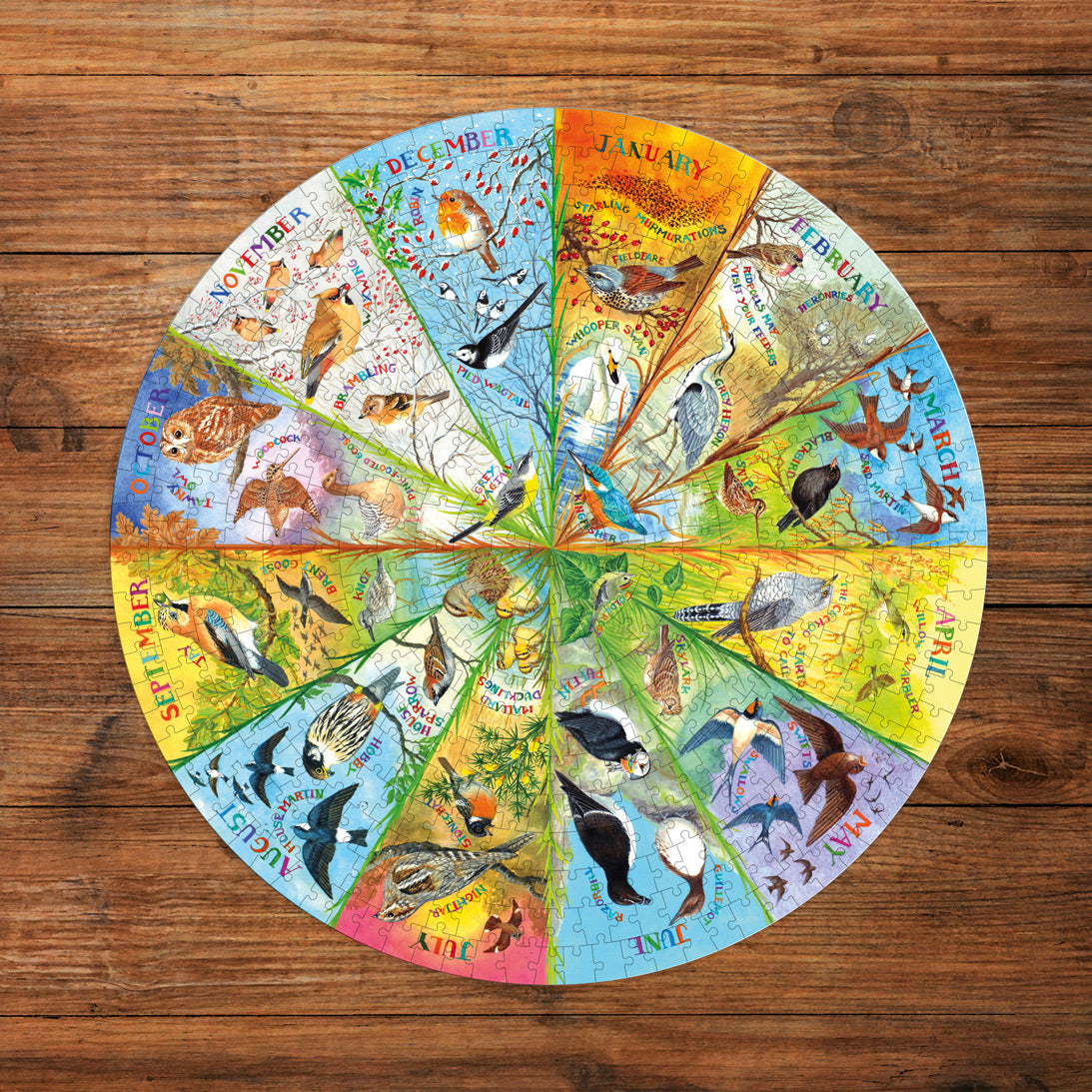 Round calendar jigsaw with seasonal animal illustrations on a wooden surface