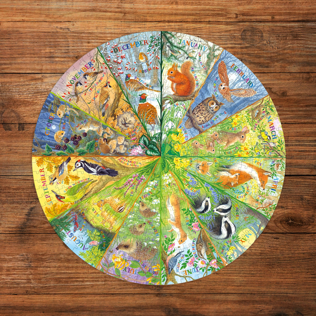 Circular calendar with animal illustrations on a wooden surface