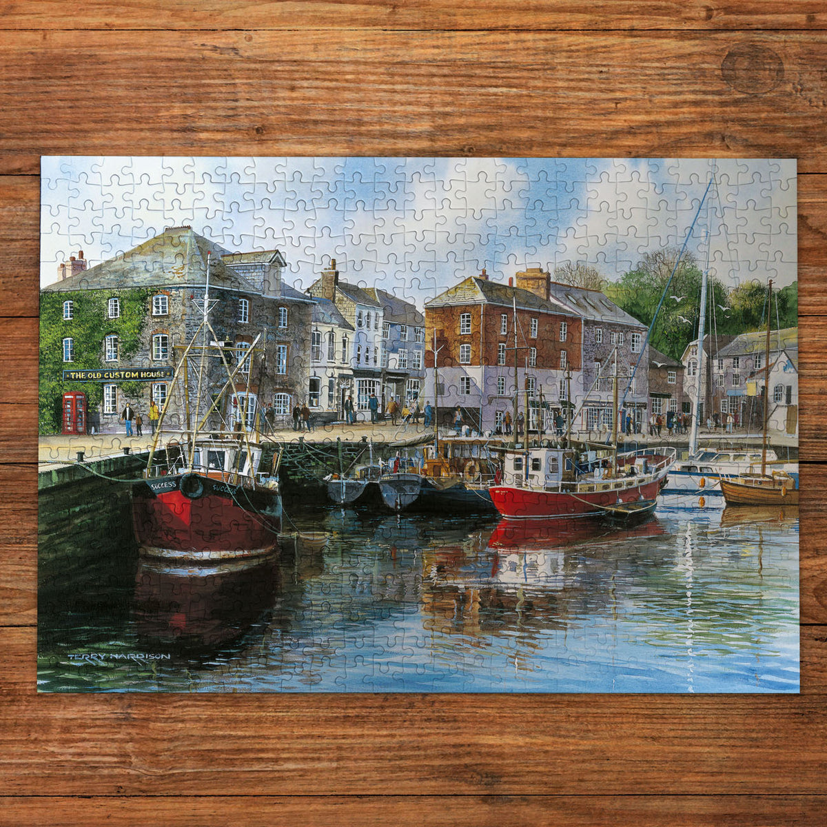 Jigsaw puzzle with a harbor scene on a wooden surface