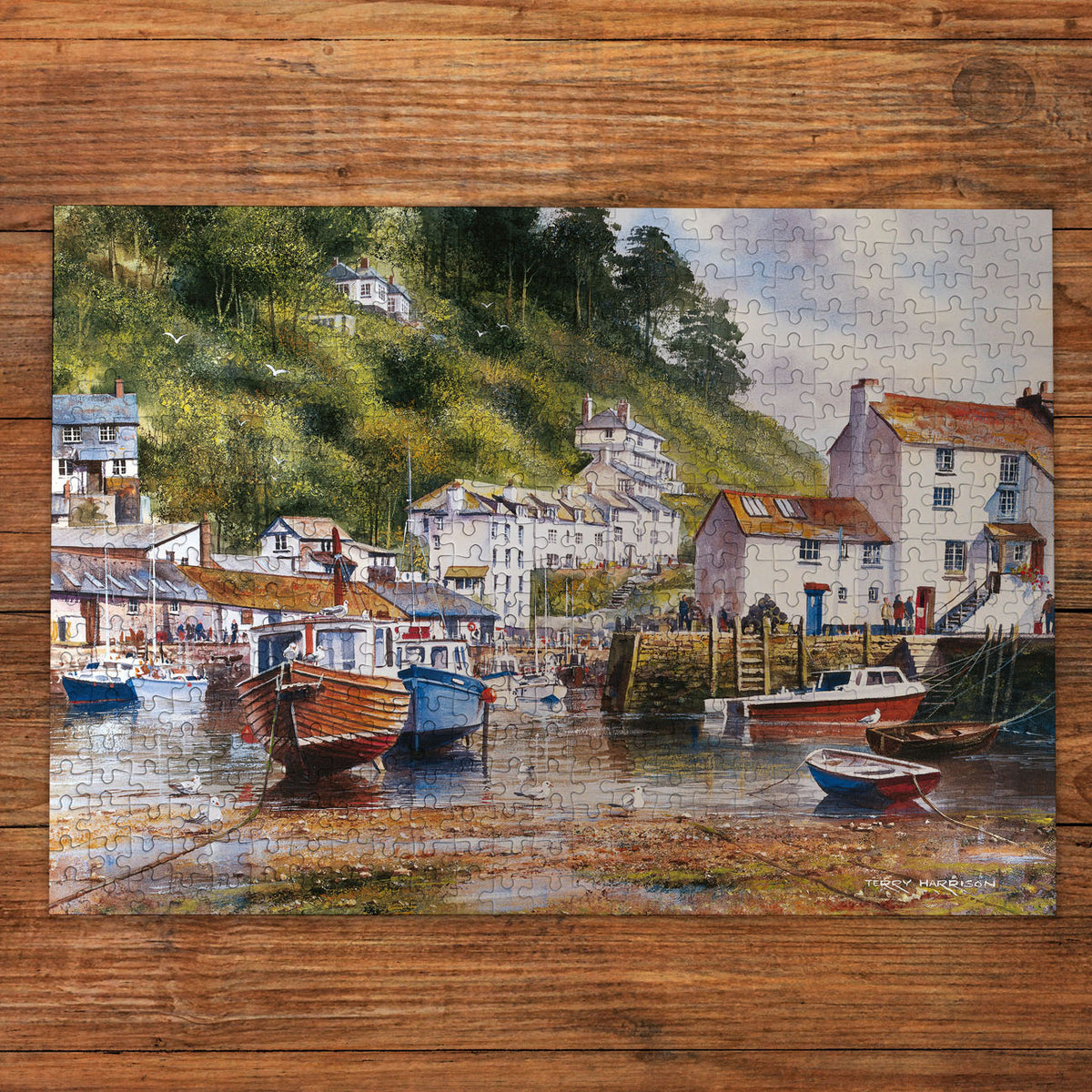 Jigsaw puzzle with a scenic village by a harbor on a wooden surface