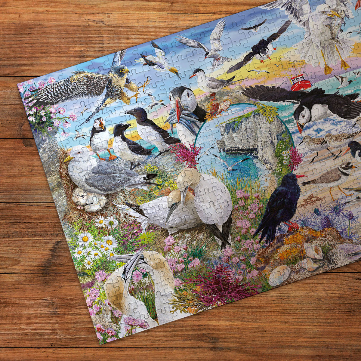 Puzzle with a colourful design of birds and nature on a wooden surface