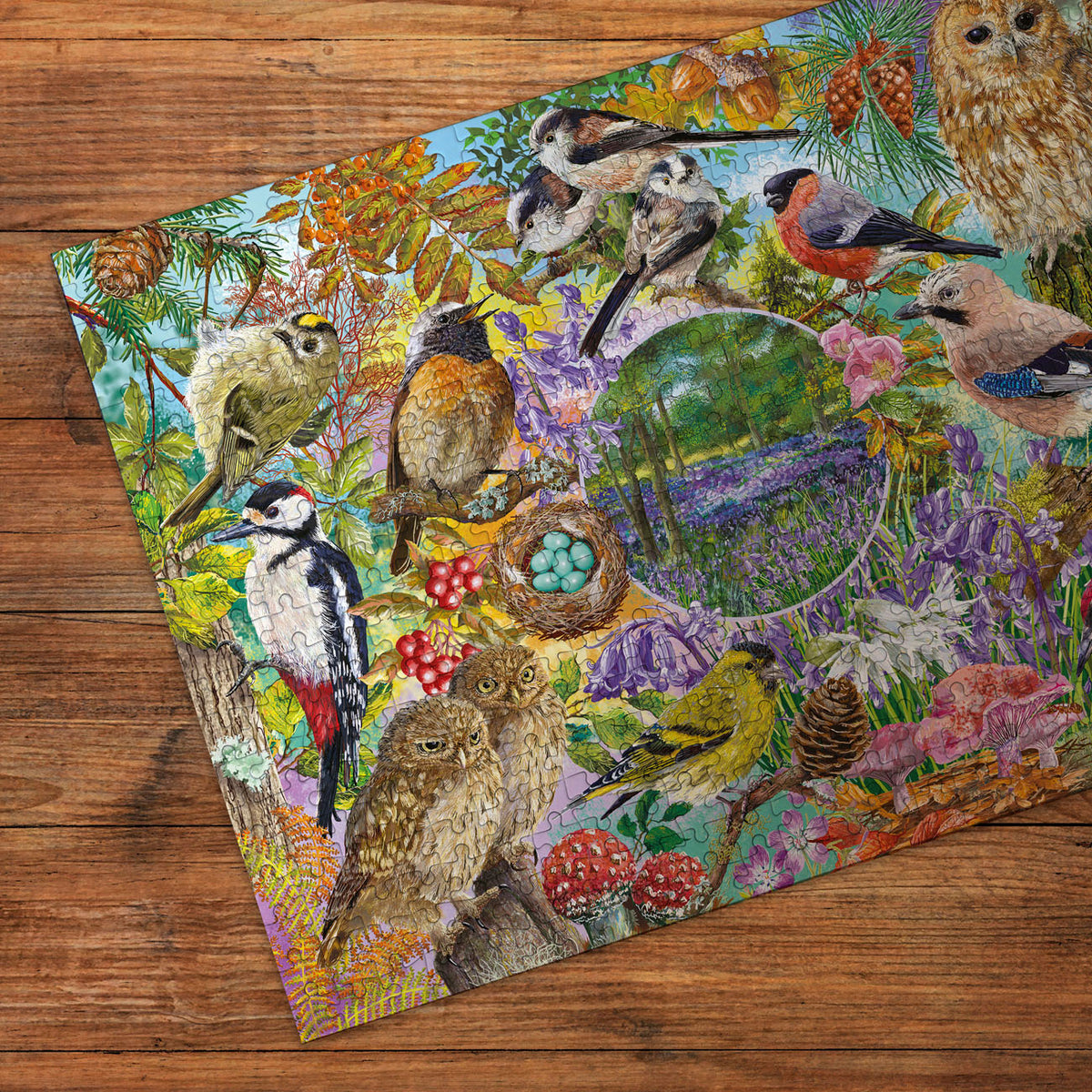Colourful nature-themed jigsaw puzzle with birds and animals on a wooden surface