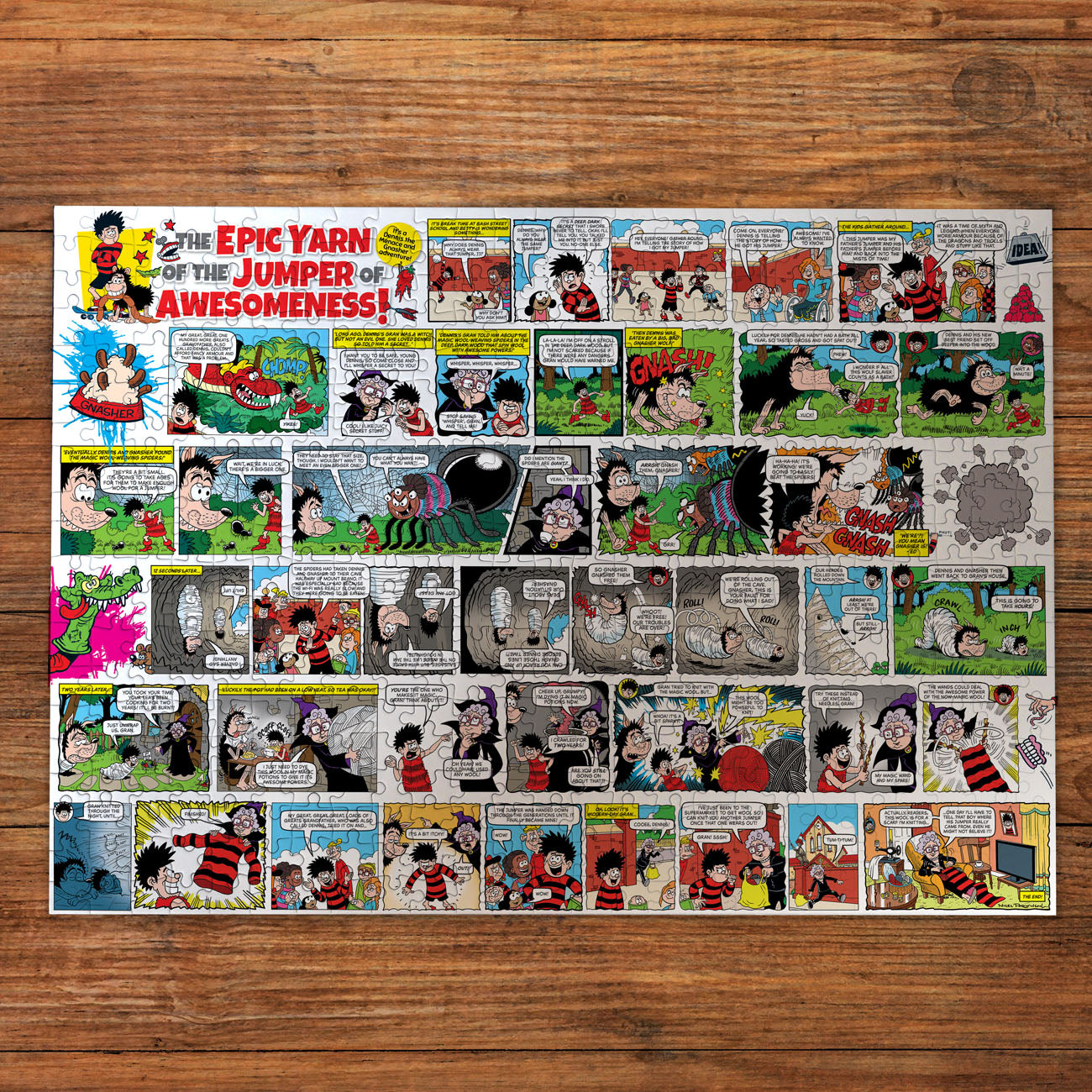 Comic strip poster titled 'The Epic Yarn of the Jumper of Awesomeness!' on a wooden surface