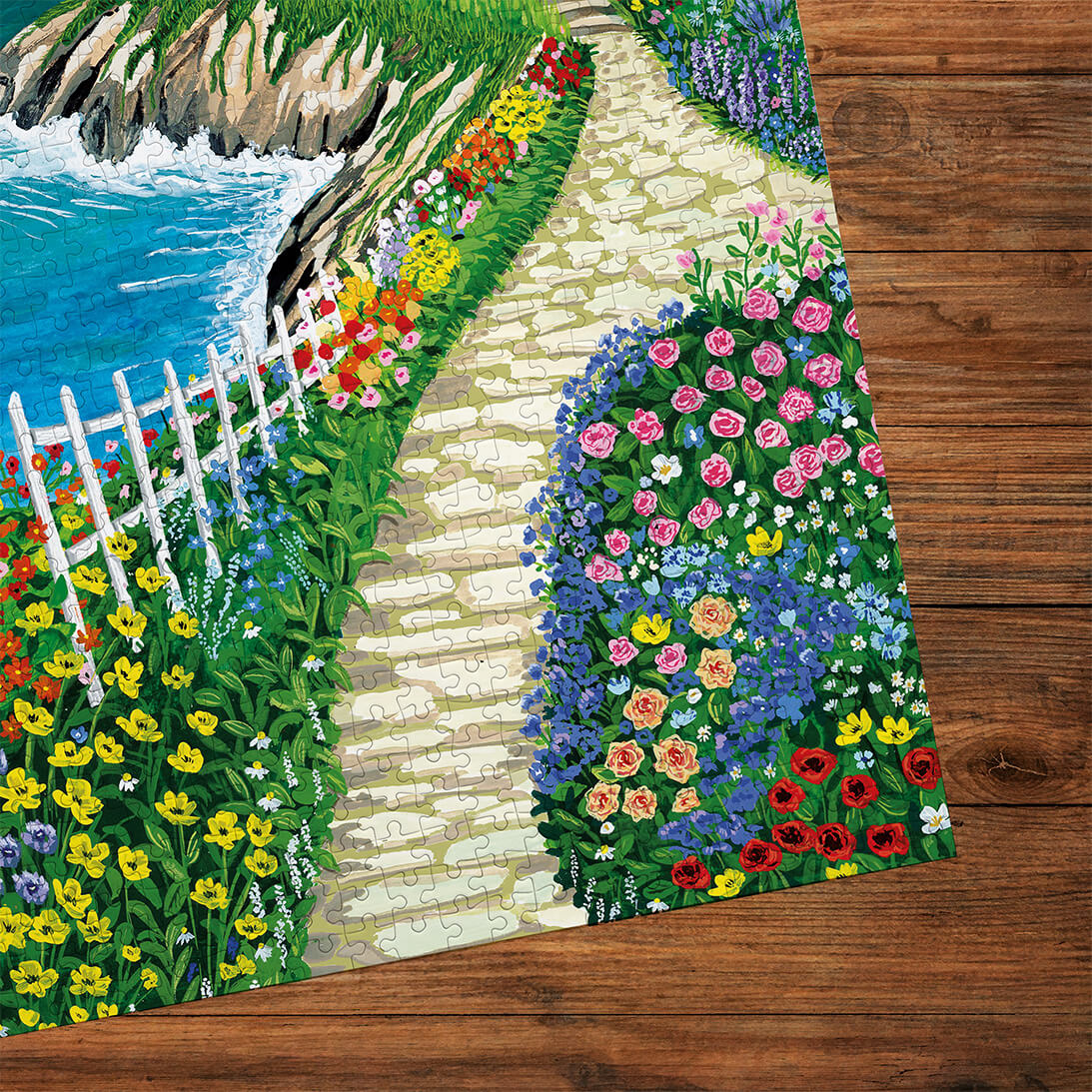 Gibsons Call of the Coast 3x500 Multi-box Gift Set Jigsaw Puzzles, Cliffside Cottage made up detail on wooden table