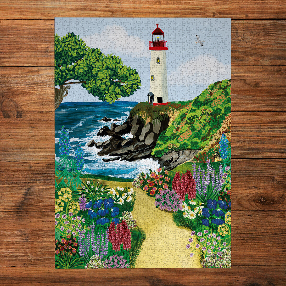 Gibsons Call of the Coast 3x500 Multi-box Gift Set Jigsaw Puzzles, the Morning Tides made up on wooden table