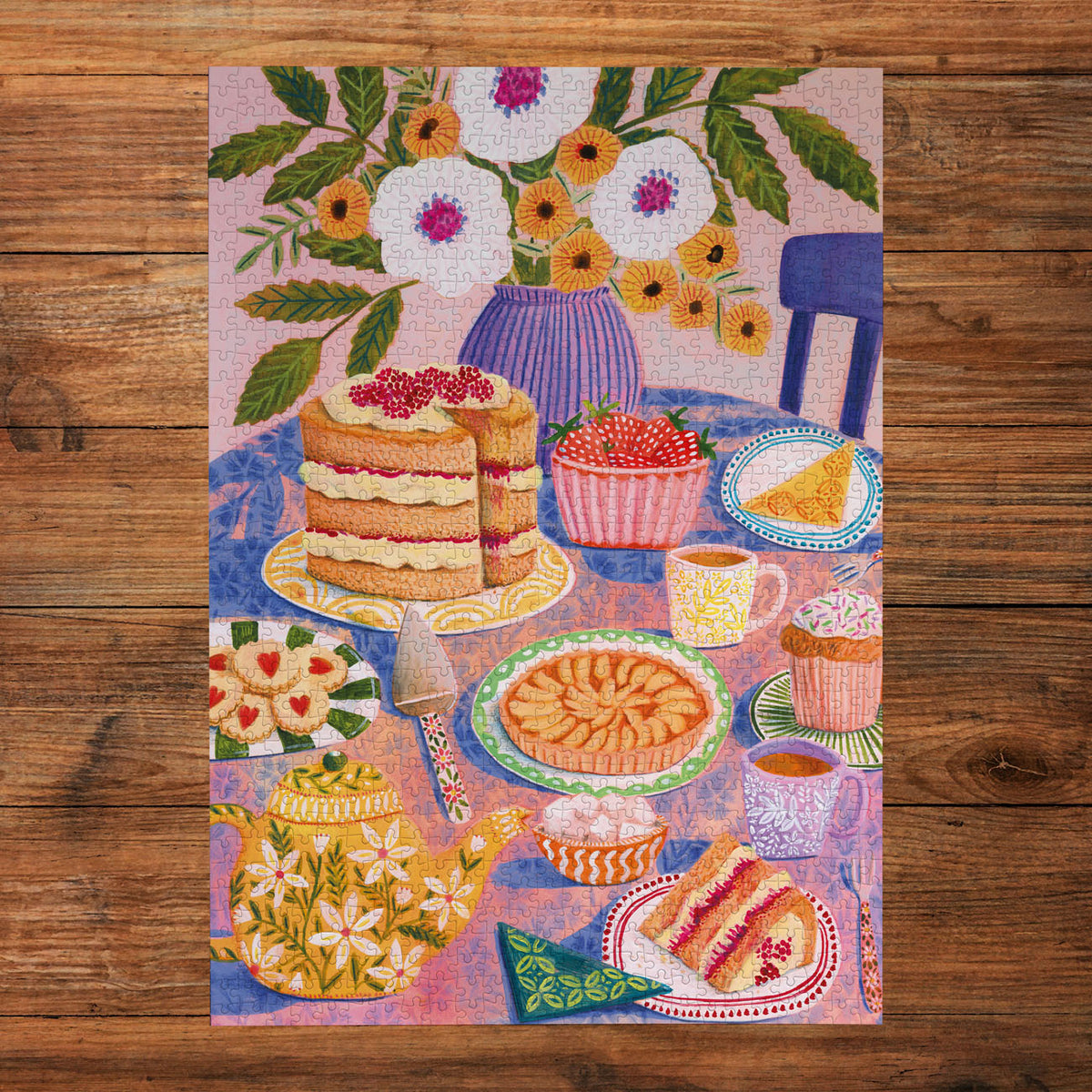 Colourful illustration of a tea party scene with cakes, teacups, and flowers on a wooden surface.