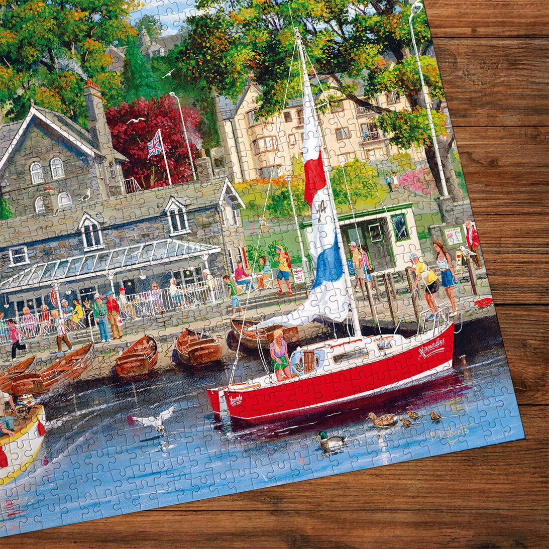 Jigsaw puzzle of a harbor scene with a red boat on a wooden surface