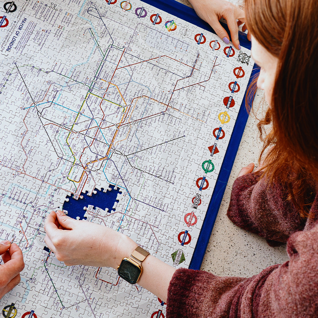 Lifestyle image of Jigsaw puzzle with a map of London's underground system in process of puzzling