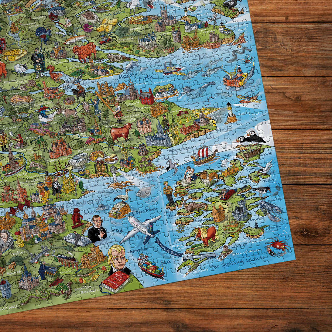 Detailed map of Scotland with illustrations on a wooden surface