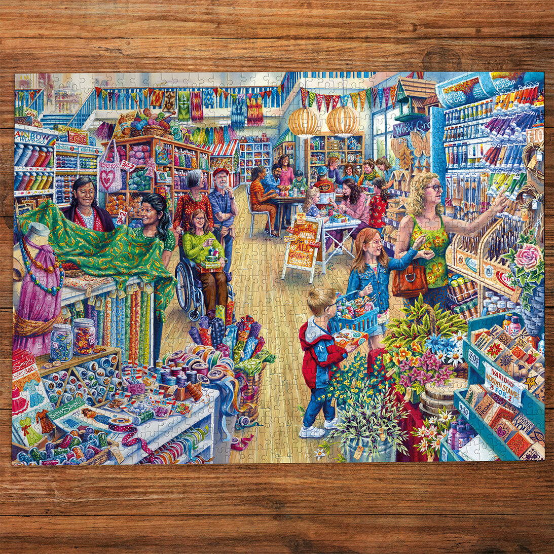Gibsons Crafter's Paradise 1000 Piece Jigsaw Puzzle made up on wooden table
