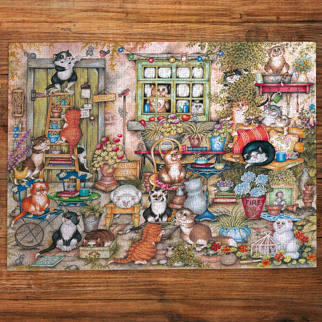 Gibsons Courtyard Cats 1000 Piece Jigsaw Puzzle made up on wooden table