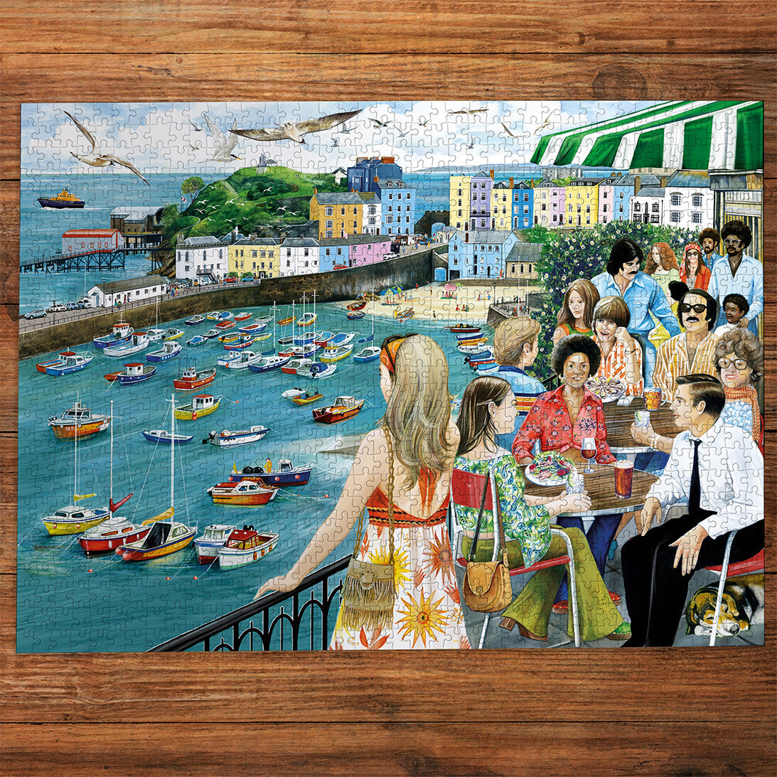 Dining at Tenby 1000 Piece Jigsaw Puzzle by Gibsons made up on wooden table