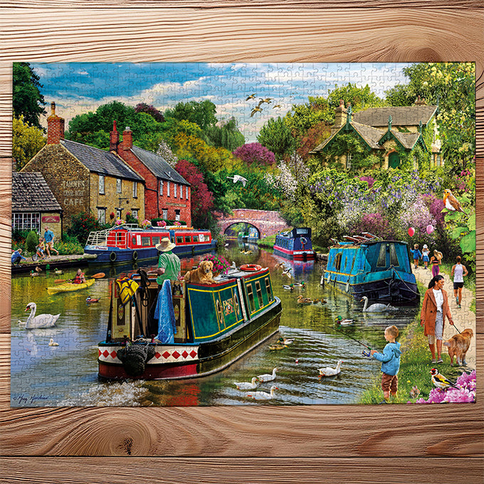 Gibsons River Retreat 1000 Piece Jigsaw Puzzle made up on wooden table