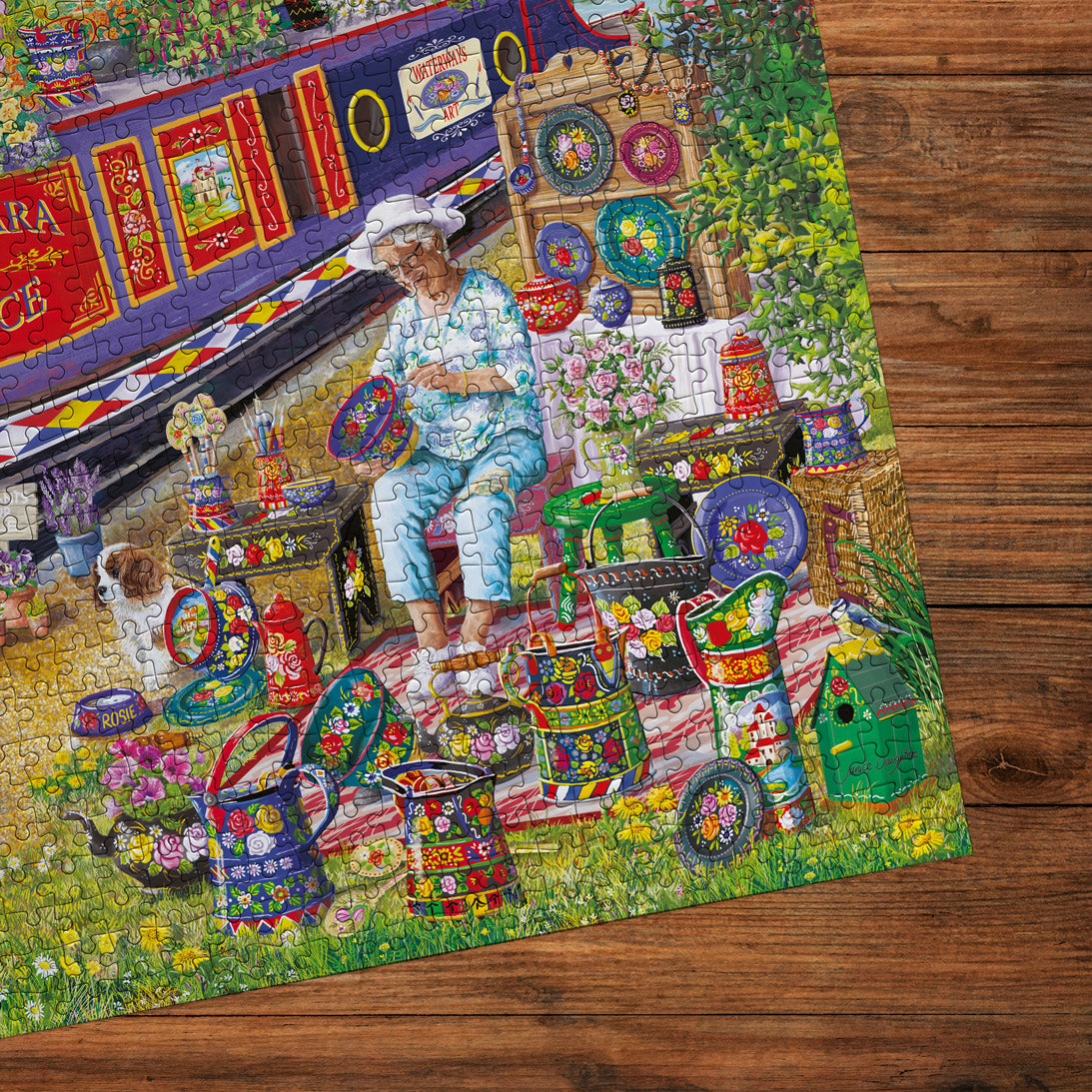 Colorful mosaic artwork of a woman in a garden with various objects and flowers on a wooden surface.