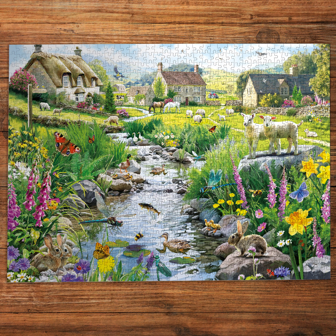Jigsaw puzzle with a scenic village and nature design on a wooden table