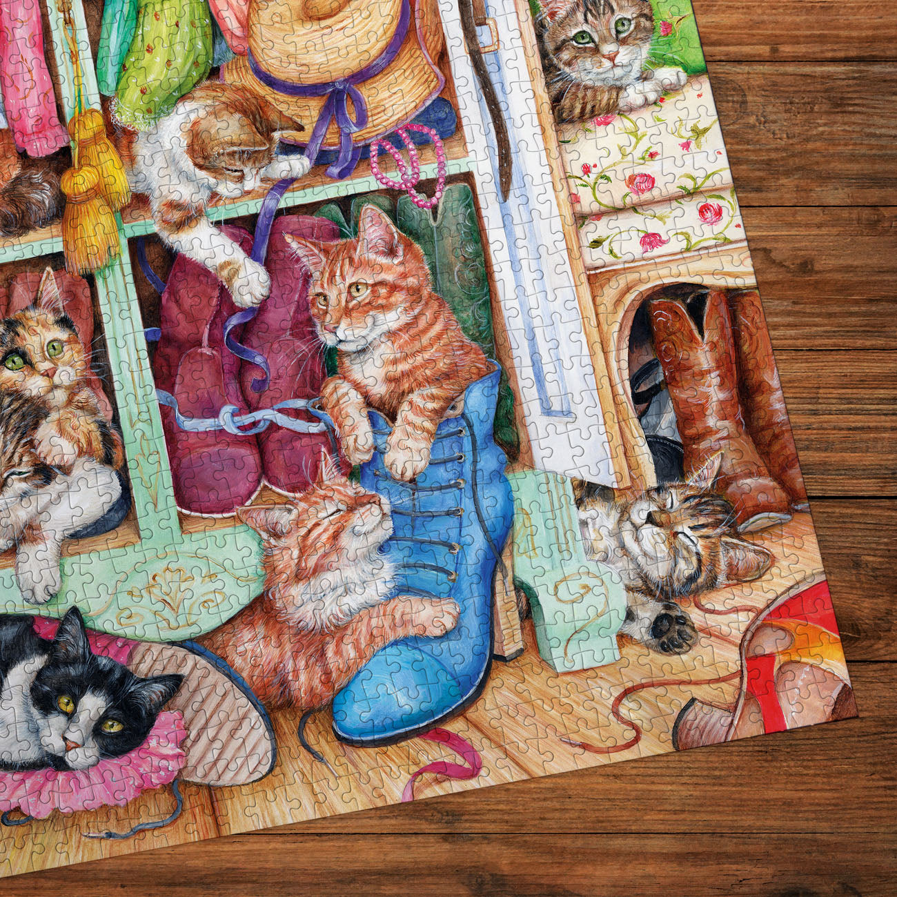 Jigsaw puzzle with a cat-themed design on a wooden surface