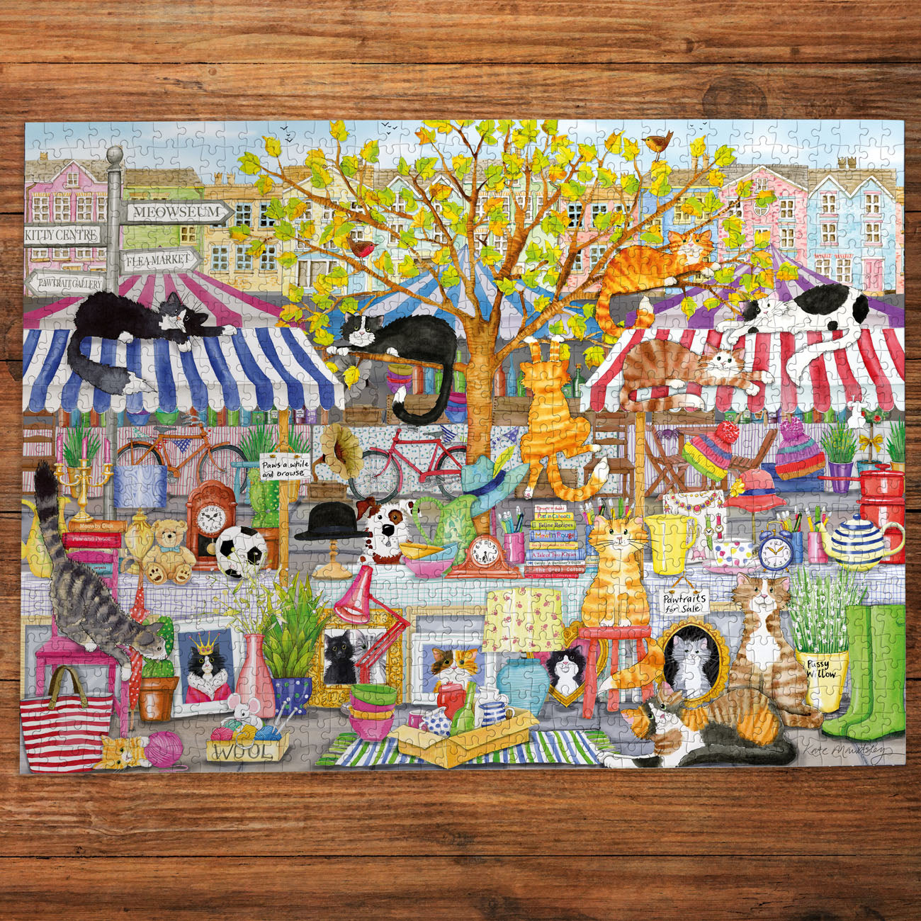 Colorful puzzle with cats in a market scene on a wooden surface