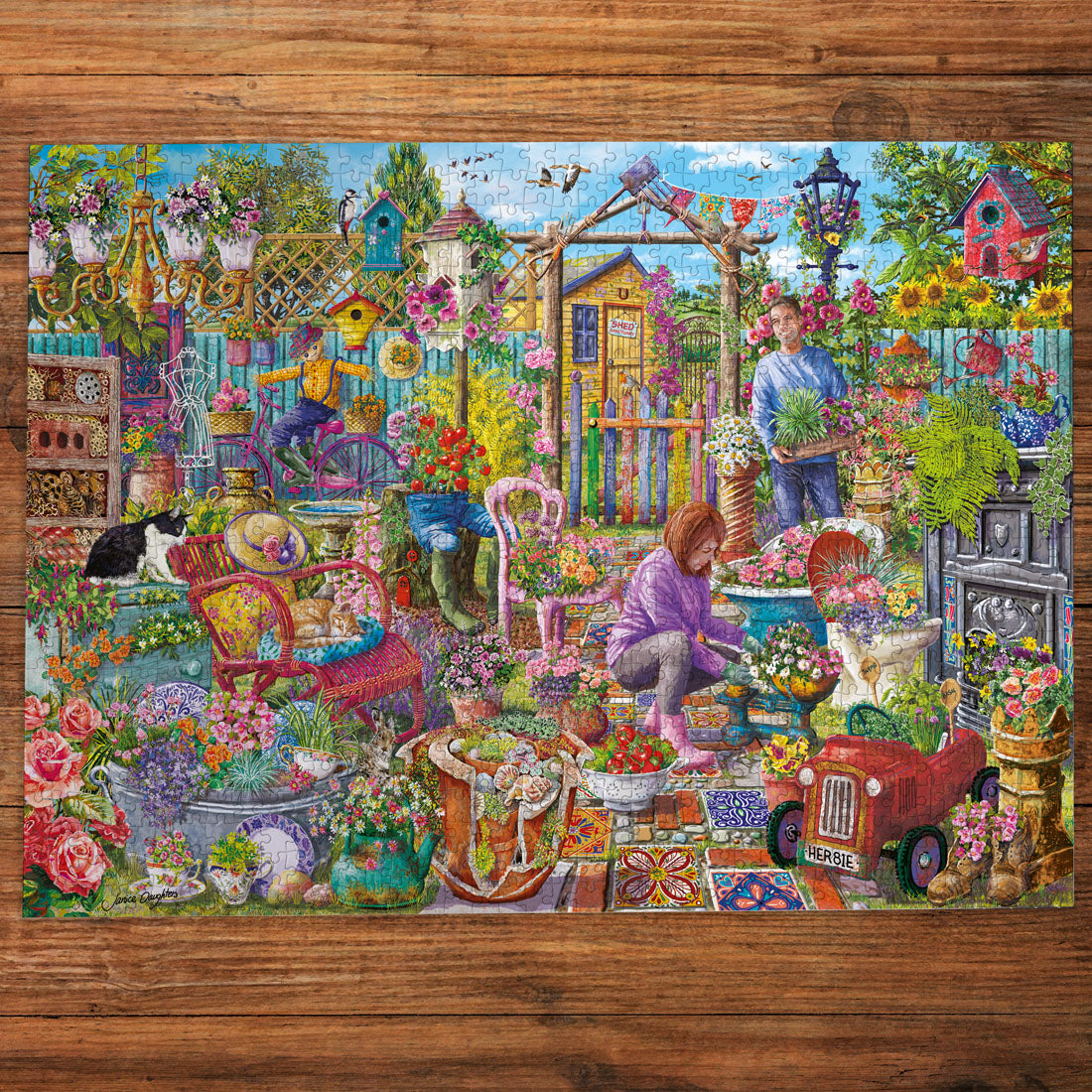 Colorful garden scene with people, animals, and various elements on a wooden surface