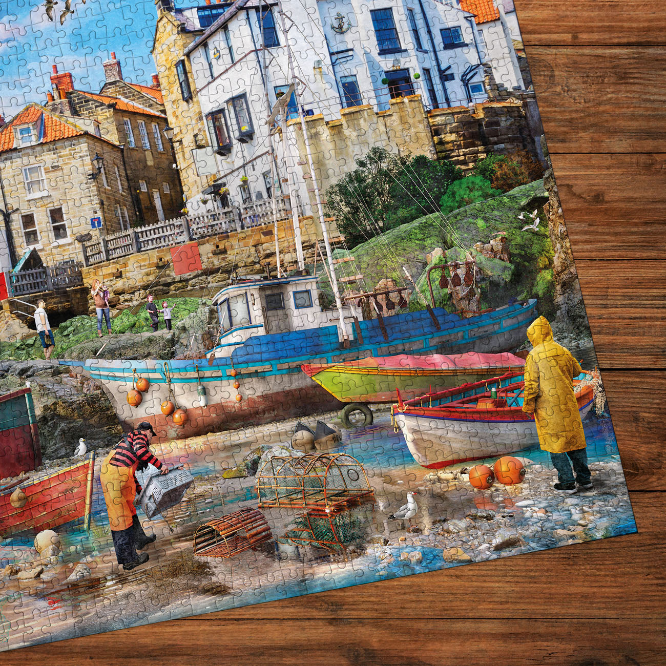 Jigsaw puzzle detail of a coastal scene with boats and people on a wooden surface