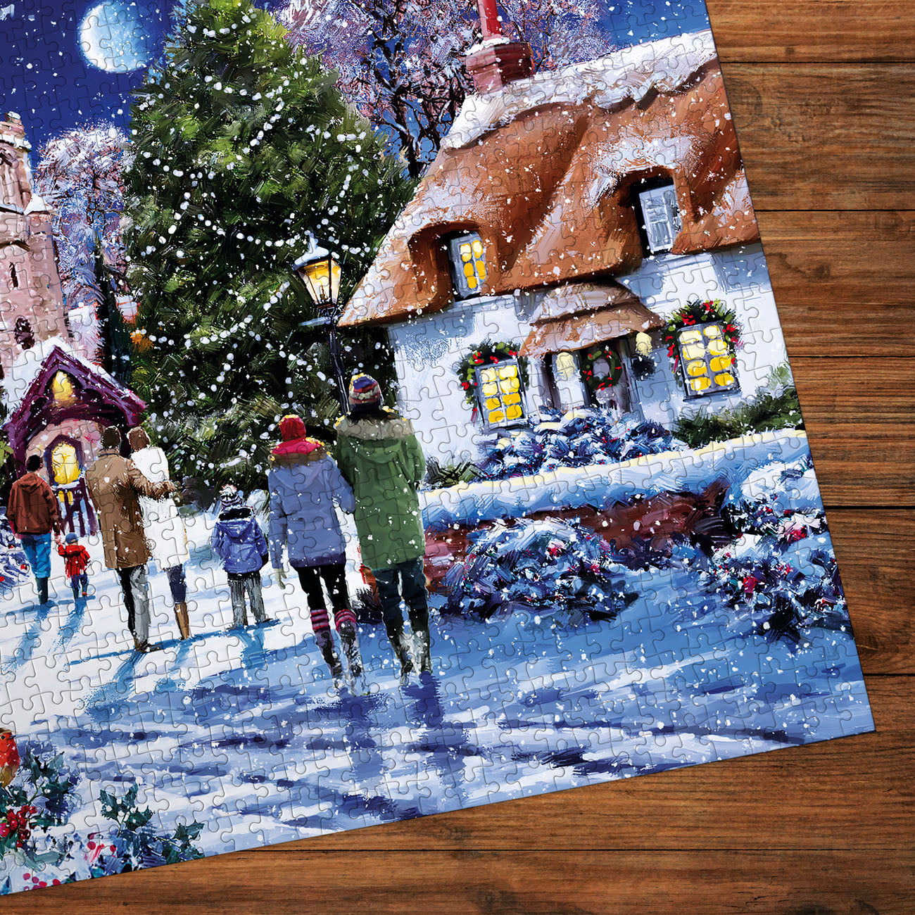 Christmas-themed puzzle with a snowy village scene on a wooden surface
