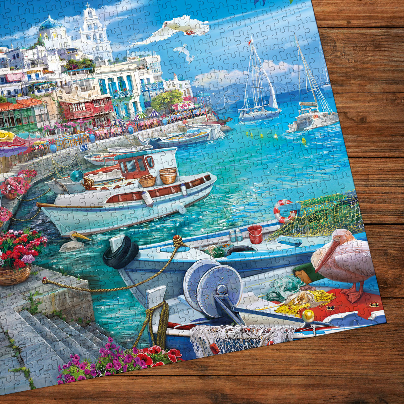 Jigsaw puzzle of a coastal scene with boats and buildings on a wooden surface