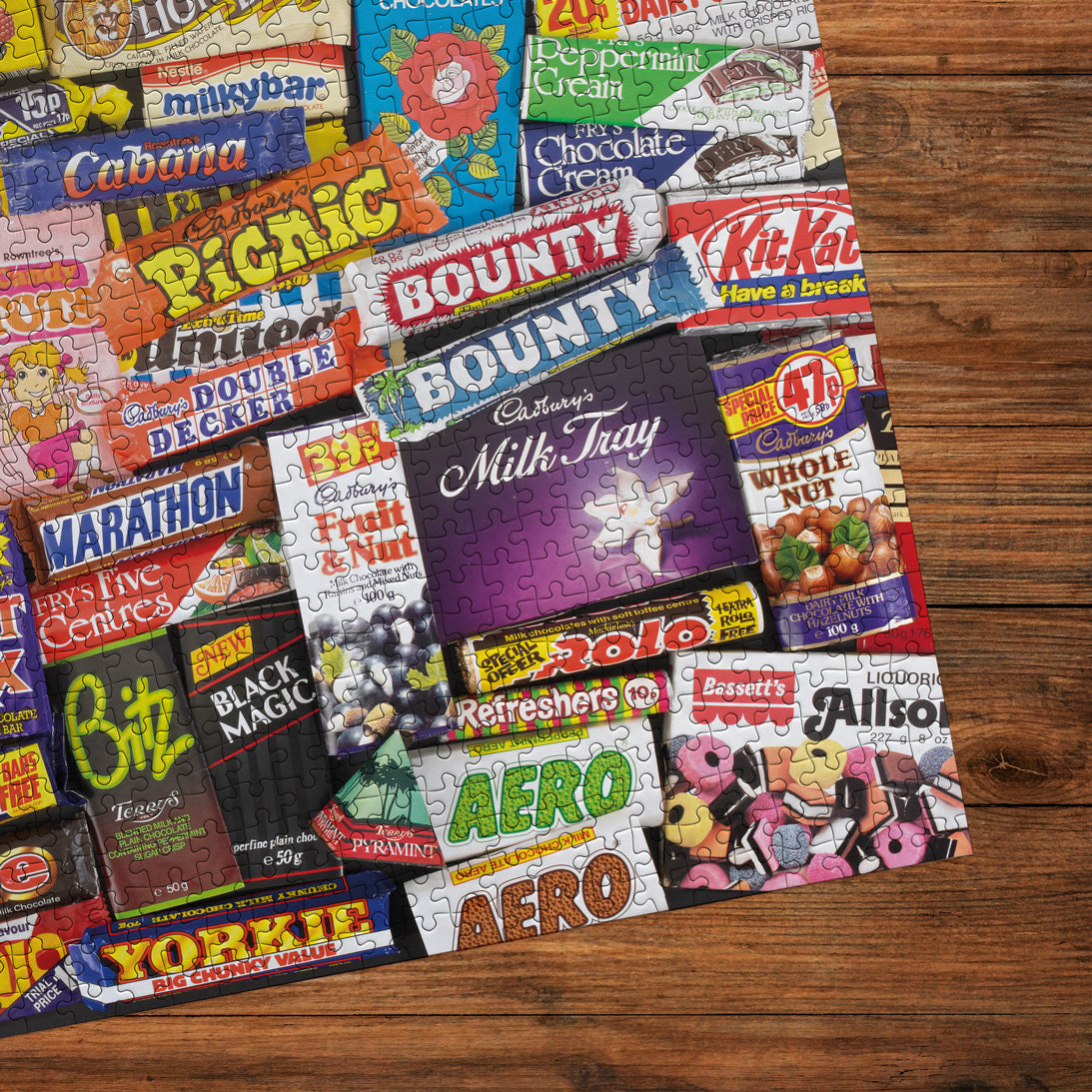 Jigsaw puzzle with vintage candy bars on a wooden surface