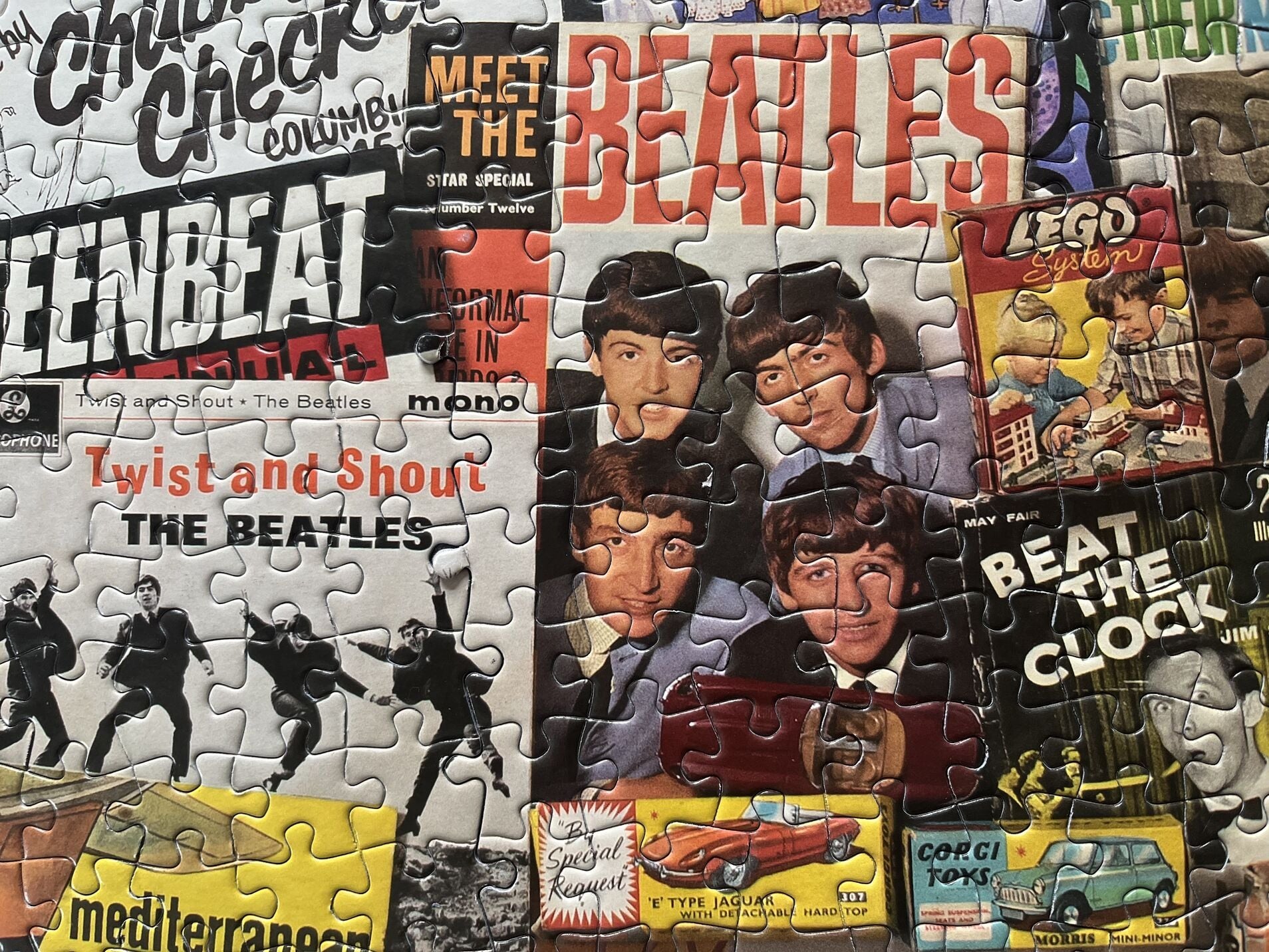 Collage of Beatles-themed puzzle pieces with various album covers and promotional materials.